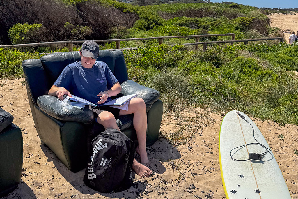 Thanos Kingsley, a year 12 student from Parramatta Marist High School, is studying at the beach.