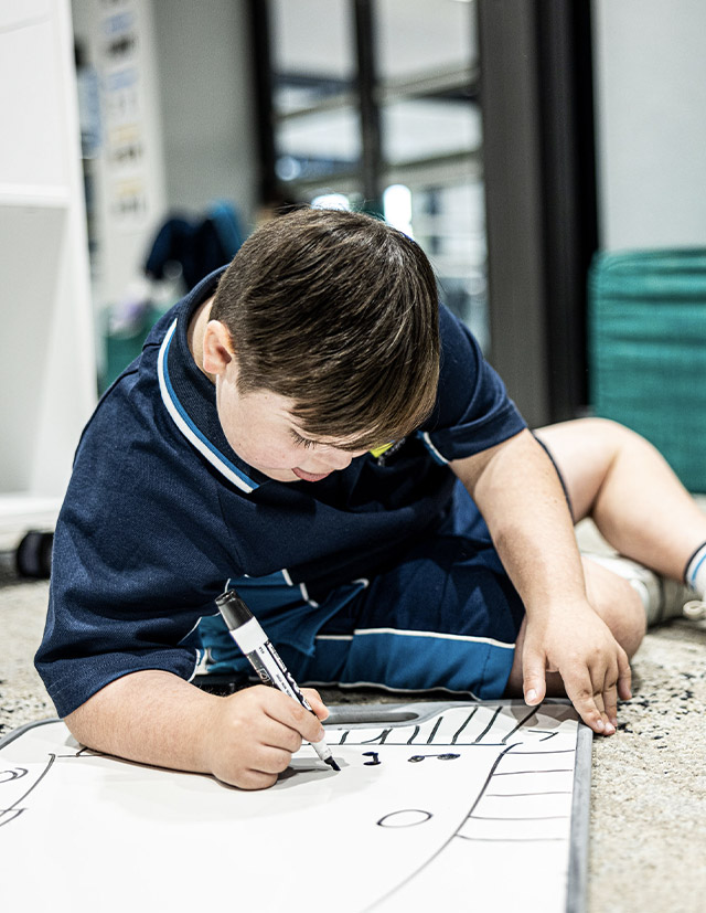 St Luke's Catholic School Marsden Park Arrunga student writing on whiteboard