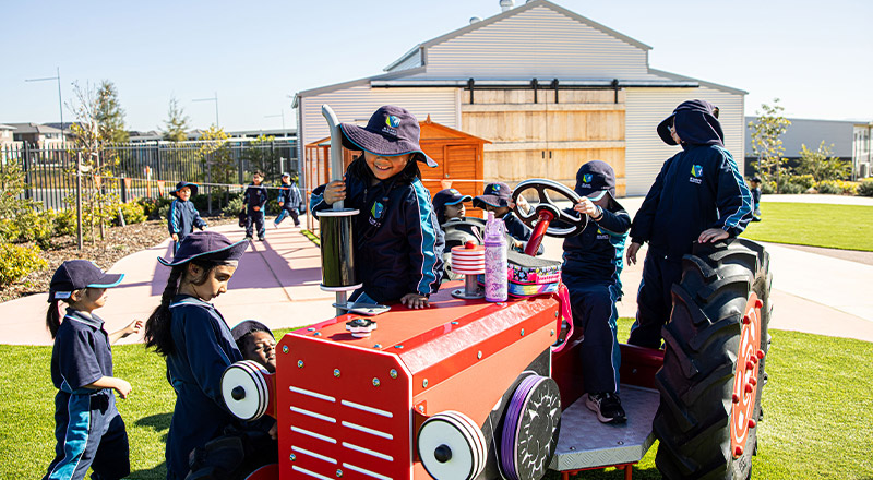 St Luke's Catholic School Marsden Park students on toy tractor
