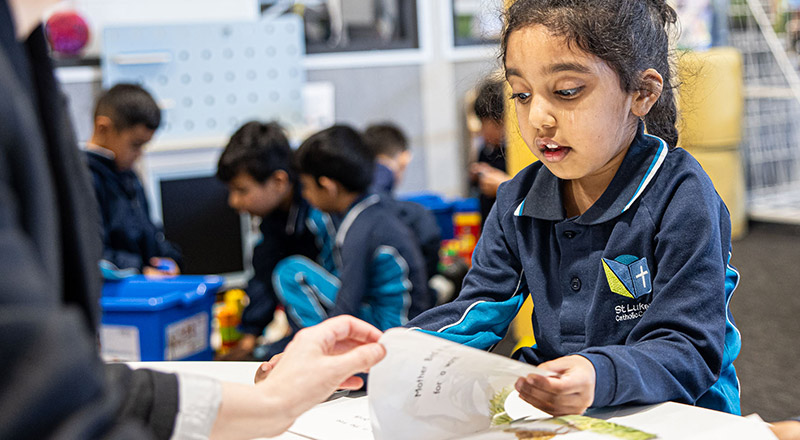St Luke's Catholic School Marsden Park student reading with teacher