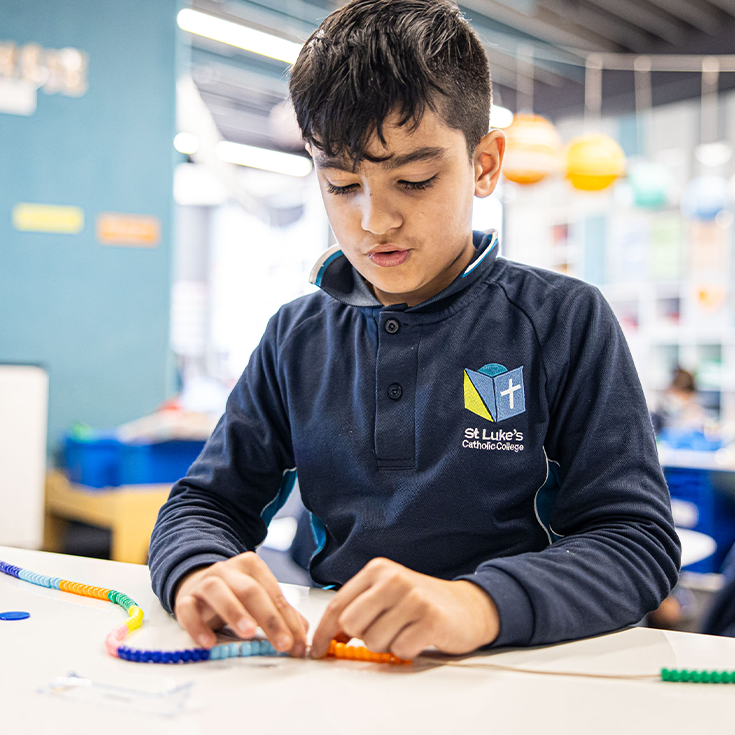St Luke's Catholic School Marsden Park student playing with beads